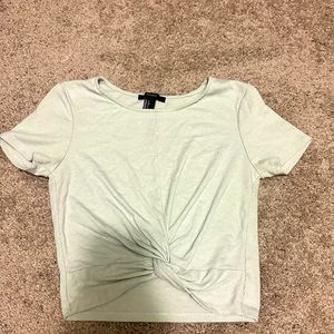 Small, mint green crop top with a scrunched knot in the front.